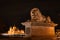 Lion statue on the Chain Bridge in Budapest - a landmark in the capital of Hungary at night with illumination