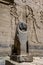 A lion statue sitting at the entrance of the first Pylon at the Temple of Isis on the island of Philae in Egypt.