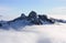 The Lions above the clouds in North Shore Mountains, BC, Canada.