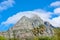 Lions Head mountain with cloudy blue sky copy space. Beautiful below view of a rocky mountain peak covered in lots of