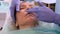 Lip augmentation. Beautician doctor doing a beauty procedure to female lips with a syringe. elderly woman. Lip