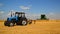 Lipetsk, Russia - August 2. 2017. Belarus tractor and harvesters are working in field to harvest grain