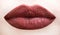 lips. Brown lip. Close up of plump soft lips with dark brown lipstick. Professional makeup lip gloss cosmetic