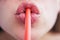 Lips close up drinking through straw. Female mouth drinking. Drinking tube is a small pipe to consume a beverage.