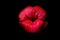 Lips kiss isolated on black. Close up of womans pouting lips with red lipstick. Beautiful red lip. Love and kissing