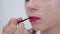 Lips painting: professional make-up artist making face makeup art