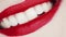 Lips with red lipstick and white teeth smiling, macro closeup of happy female smile, dental health and beauty makeup