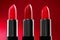 Lipstick. Fashion red Colorful Lipsticks over red background. Red lipstick tints palette, Professional Makeup and beauty