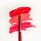 Lipstick and lip gloss, drops and strokes of different shades With brushes for application and shading