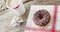 Lipstick mark on coffee cup and chocolate doughnut with sprinkles