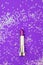 Lipstick purple on a purple background with sparkles. Vertical p