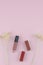 Lipsticks and lip gloss decorate with white dried flowers