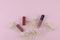 Lipsticks and lip gloss decorate with white dried flowers