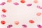Lipstiick and multiple colorful lipstick marks on a white paper
