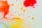 Liquid bright aquarel colours with oil generate fluid structures and bubbles in red, orange, yellow, blue, white and pink