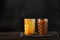 Liquid brown caramel in glass on dark background