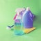 Liquid detergents in plastic bottles, household cleaning products on the table, green background