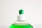 Liquid dishwasher soap bottle close up shot of green dispenser nozzle