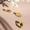 Liquid gelatin capsules with flower shadow on pink background