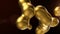 Liquid gold abstract background. Melting golden spheres on dark backdrop. luxury