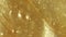 Liquid gold gel. Molten gold. Sparkling yellow liquid paint flow overlay. Motion, rotation of the cosmetic produc. Macro