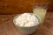 Liquid milk whey in a glass and cottage cheese in bowl on rustic wooden background. Dairy production