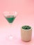 Liquid spirulina green drink in cocktail glass on pink background.