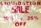 LIQUIDATION SALE sign in red with plant reflections in window.