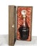 Liquor in fancy crystal bottle packaged in elegant oak wood box with red cloth