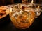 Liquor glass with ice on dark table, yellow amber alcoholic beverage. Whiskey, single malt, Brandy, scotch, cognac, bourbon