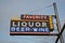 Liquor sign with blue sky in the background