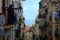 Lisbon narrow alley with old residential buildings and drying cloths