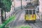 LISBON - NOVEMBER 1, 2018: Yellow tram speeds up along city street. Lisbon attracts 3 million tourists annually