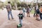 Lisbon, Portugal 01 may 2018: Caring fathers walk with their children and teach them to ride skateboards and scooters