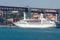Lisbon, Portugal - April 03, 2010: ocean liner in sea port. Ship on water under bridge on sunny day. Water vessel on