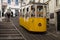 Lisbon, Portugal - May 13, 2018: Yellow Bica elevator tram on steep street, Lisbon, Portugal