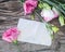 Lisianthus bouquet on a wooden table with blank note