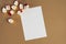 List of paper for text with copy space and Christmas lights on beige. Mockup