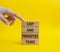 List and prioritize tasks symbol. Concept words List and prioritize tasks on wooden blocks. Beautiful yellow background.