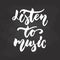 Listen to Music - hand drawn Musical lettering phrase isolated on the black chalkboard background. Fun brush chalk