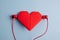 Listen to your heart. Red origami heart with headphones on blue background. Love listening to music