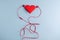 Listen to your heart. Red origami heart with headphones on blue background. Love listening to music