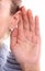 Listening: closeup view of female hand on her ear