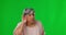 Listening, hear and senior woman on green screen with hand gesture for deaf, hearing problem and whisper. Communication