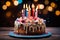 Lit candles adorn a colorful birthday cake on a wooden table