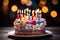 Lit candles adorn a colorful birthday cake on a wooden table