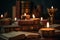 Lit candles surrounded by books on Ayurveda, ancient scriptures and panchakarma rejuvenation therapy. Set a sacred, meditative
