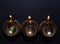 Lit diyas on dark background, flat lay. Diwali lamps