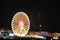 Lit ferris wheel on a funfair at night