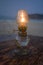 Lit kerosene lantern on beach